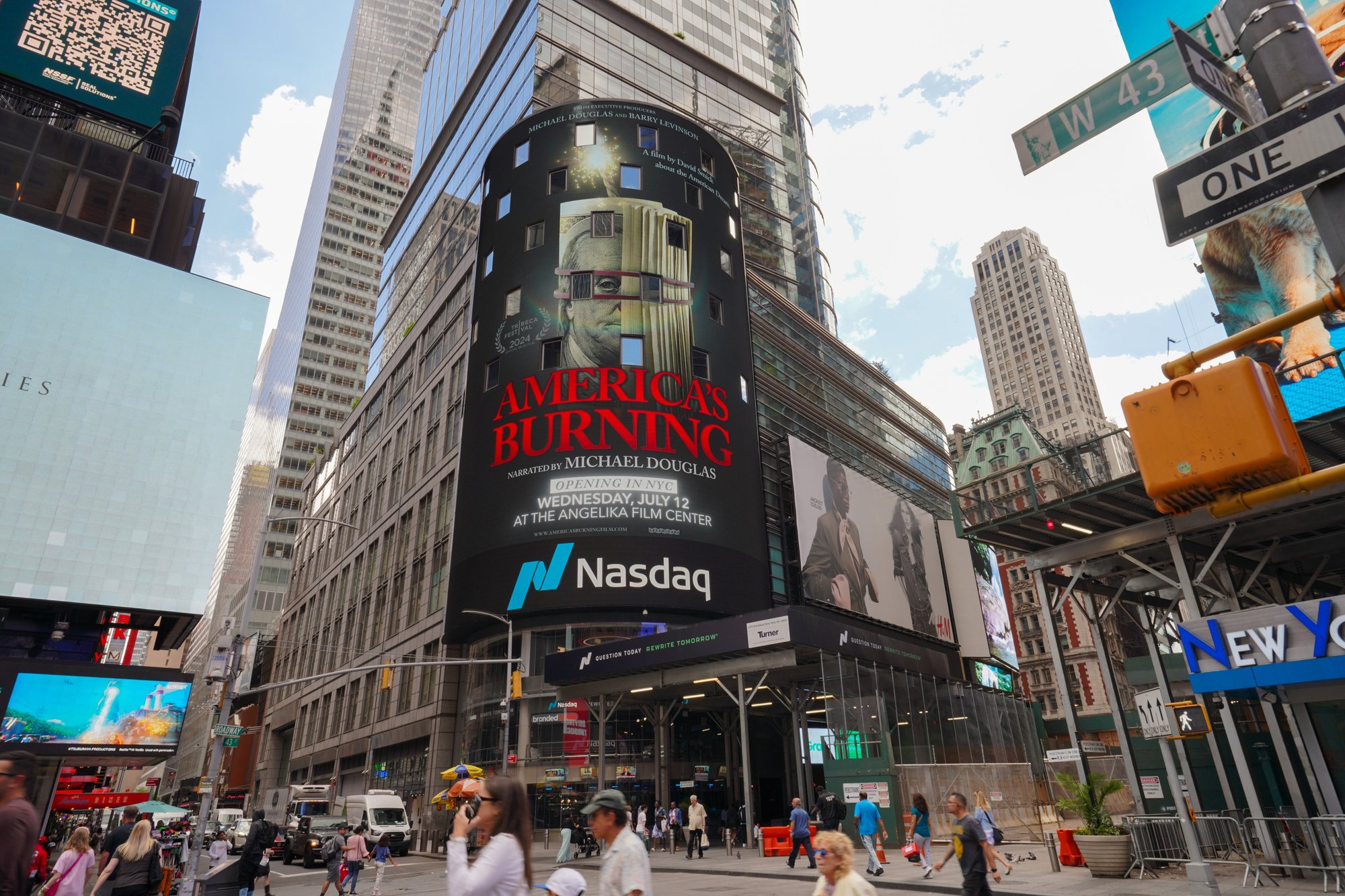 America's Burning on the Nasdaq Tower in Times Square, opening July 12 at the Angelika Film Center